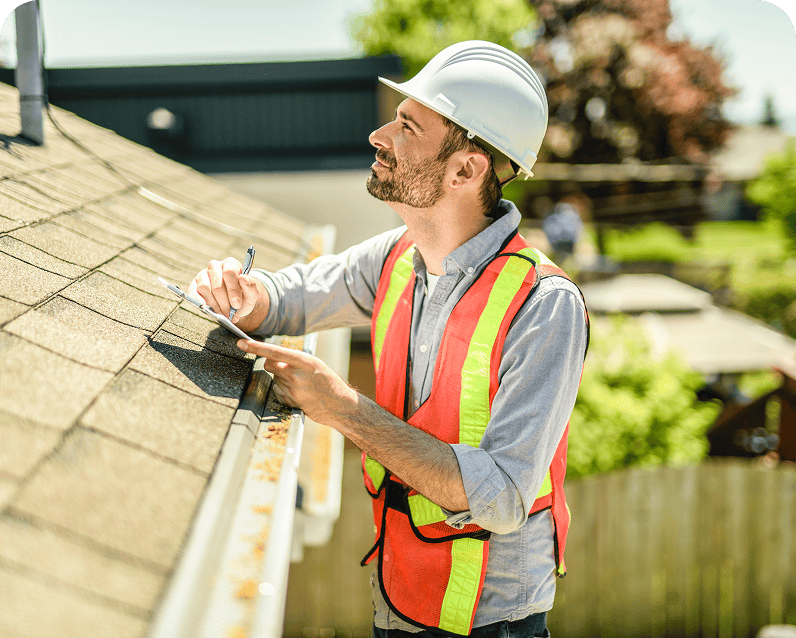 Inspector examining roof with clipboard