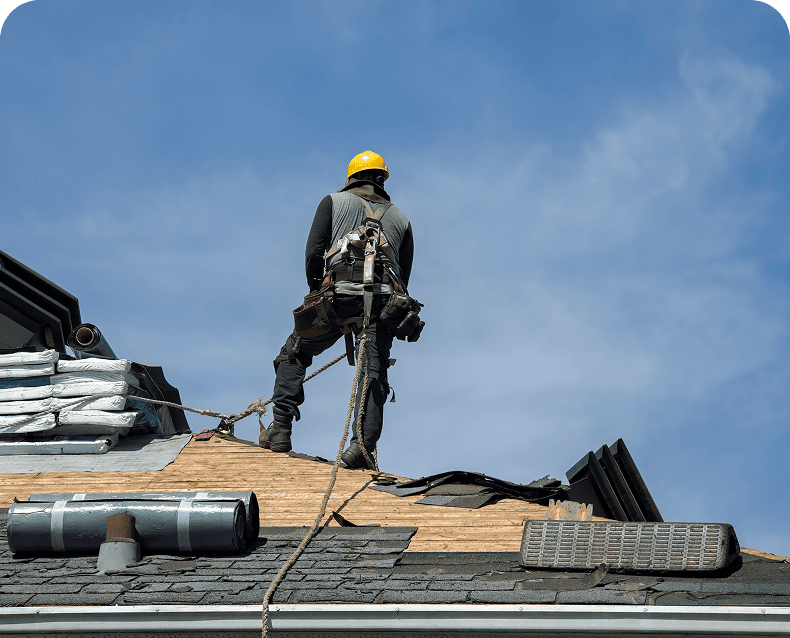 Roofer working on house roof