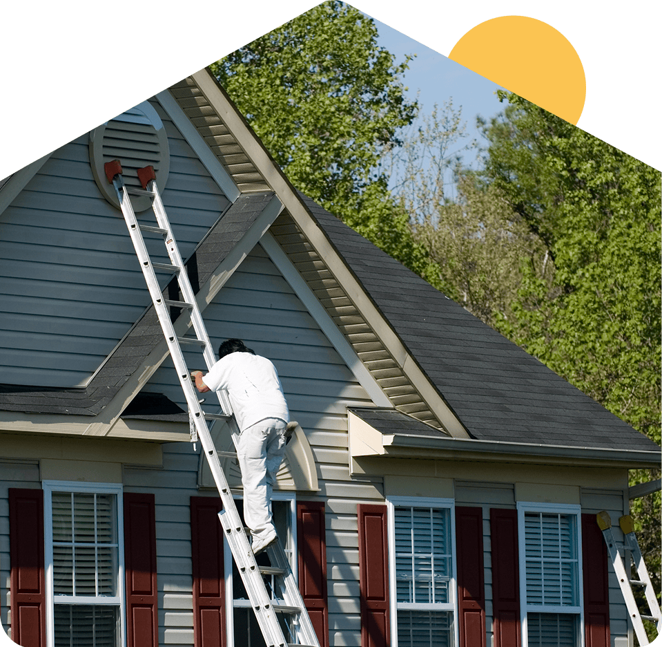 Person climbing ladder to house roof