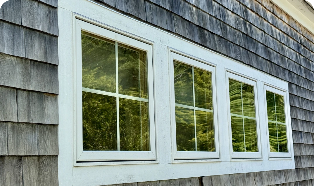 Exterior wall with multiple white-framed windows.